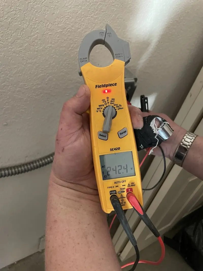 Voltage testing with clamp meter during Electrical Installation Services in Aurora